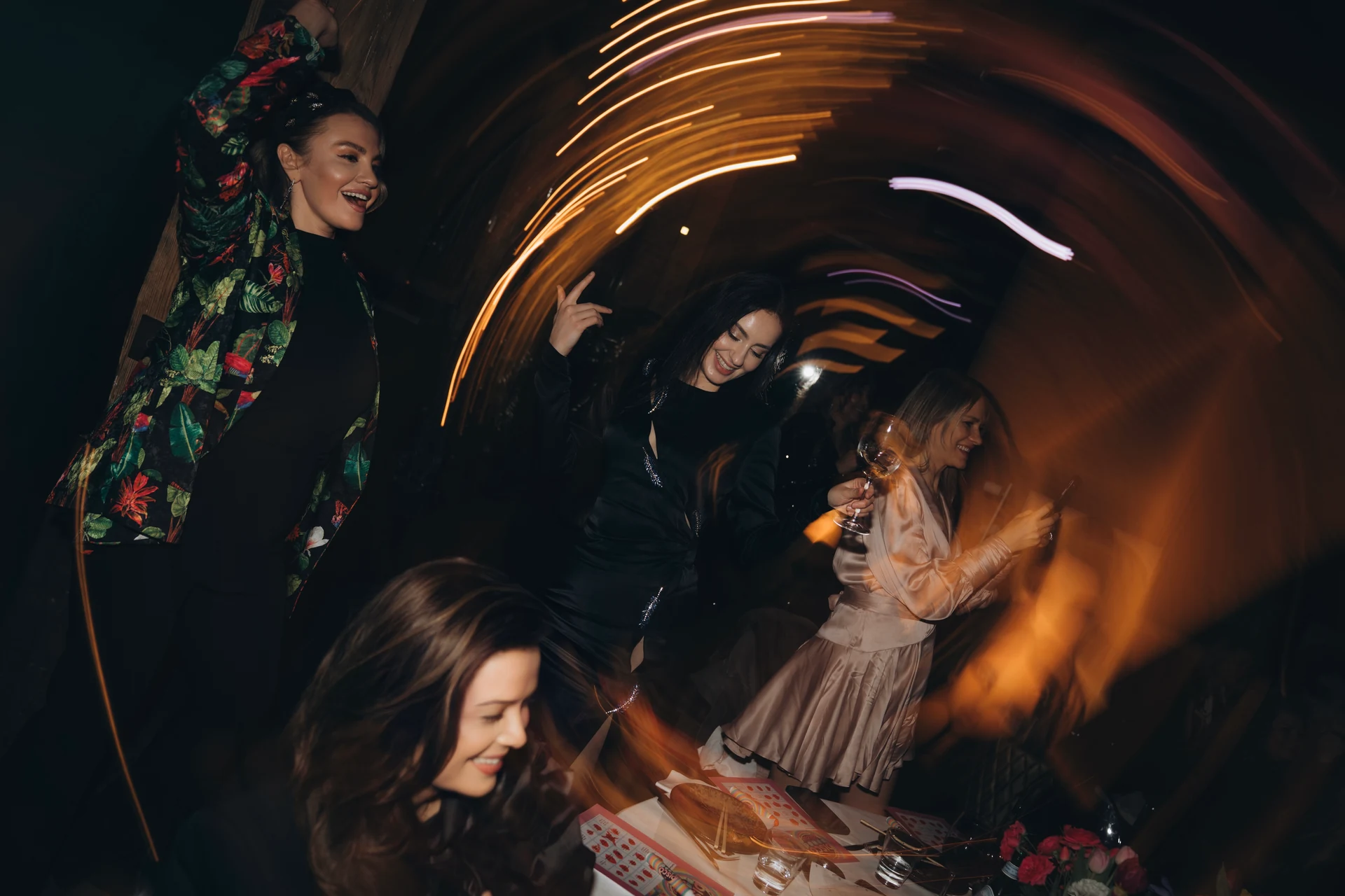 Candid dance-floor moment with colourful light trails
