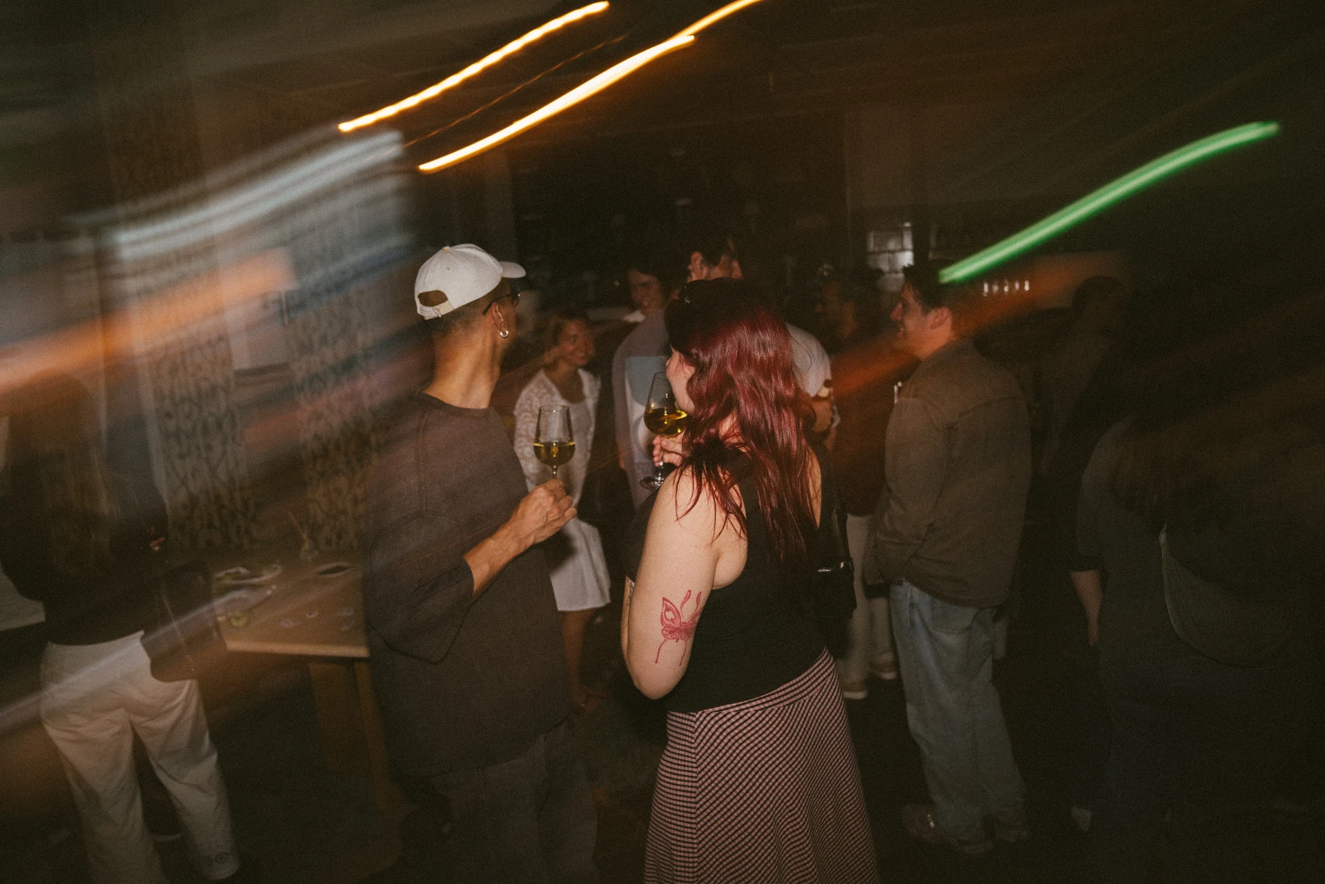 Two party guests surrounded by green light trails