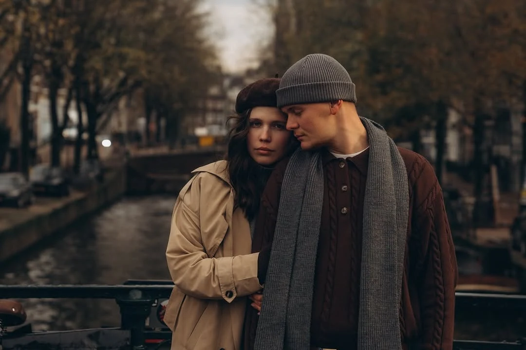Couple leaning together on a canal bridge