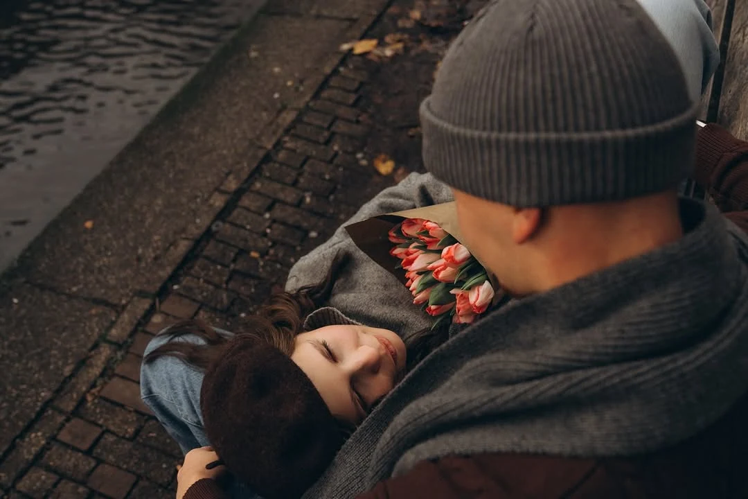 Couple holding each other beside the canal