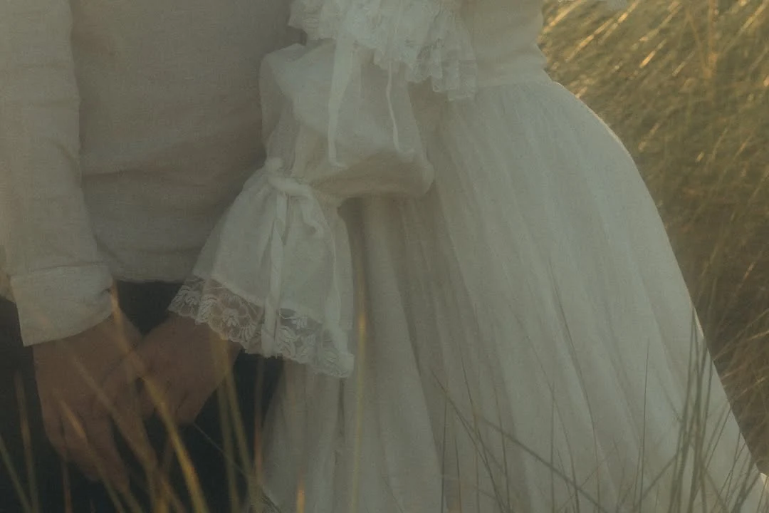 Soft detail of a white dress moving in coastal light