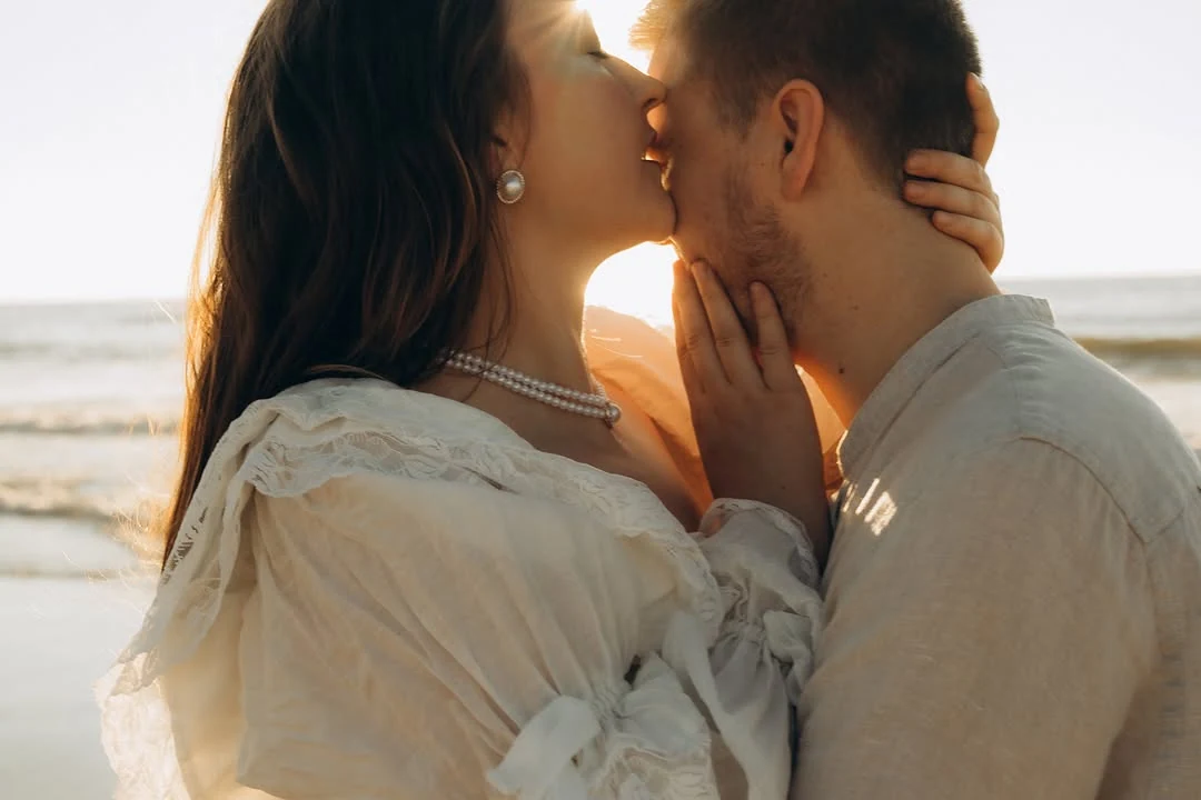 Couple kissing in golden light on the beach