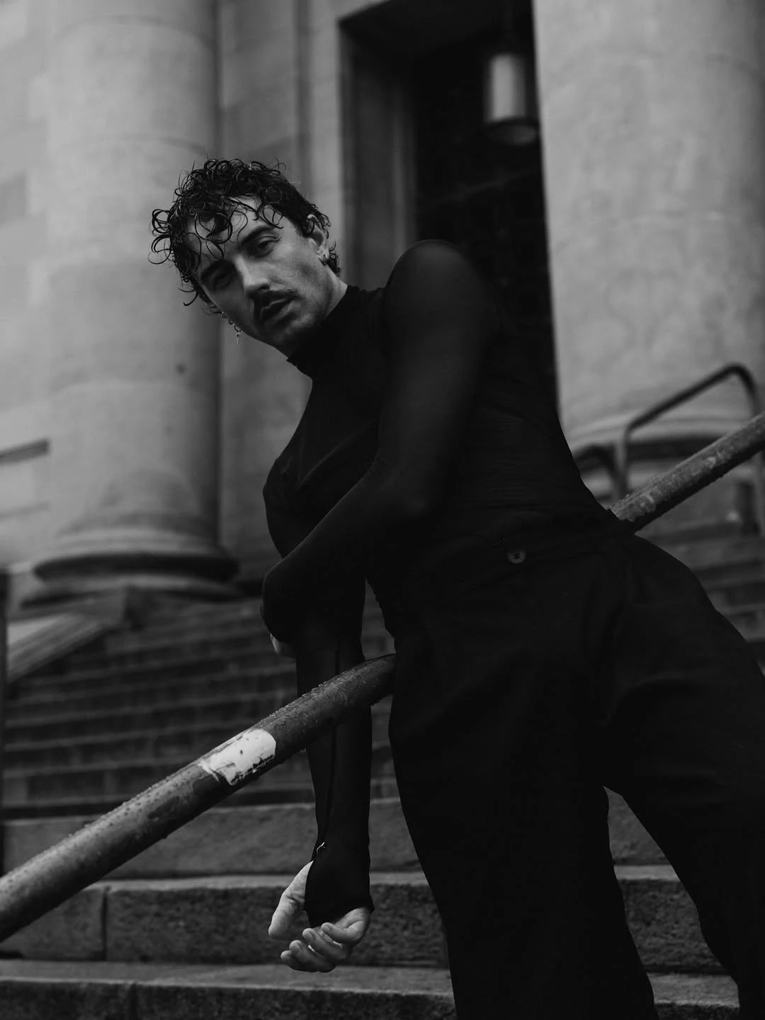 Expressive black-and-white portrait on stone steps