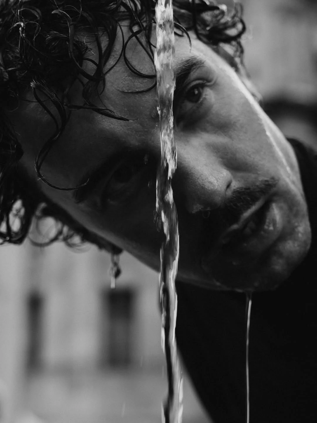 Close black-and-white portrait with textured hair and expressive eyes