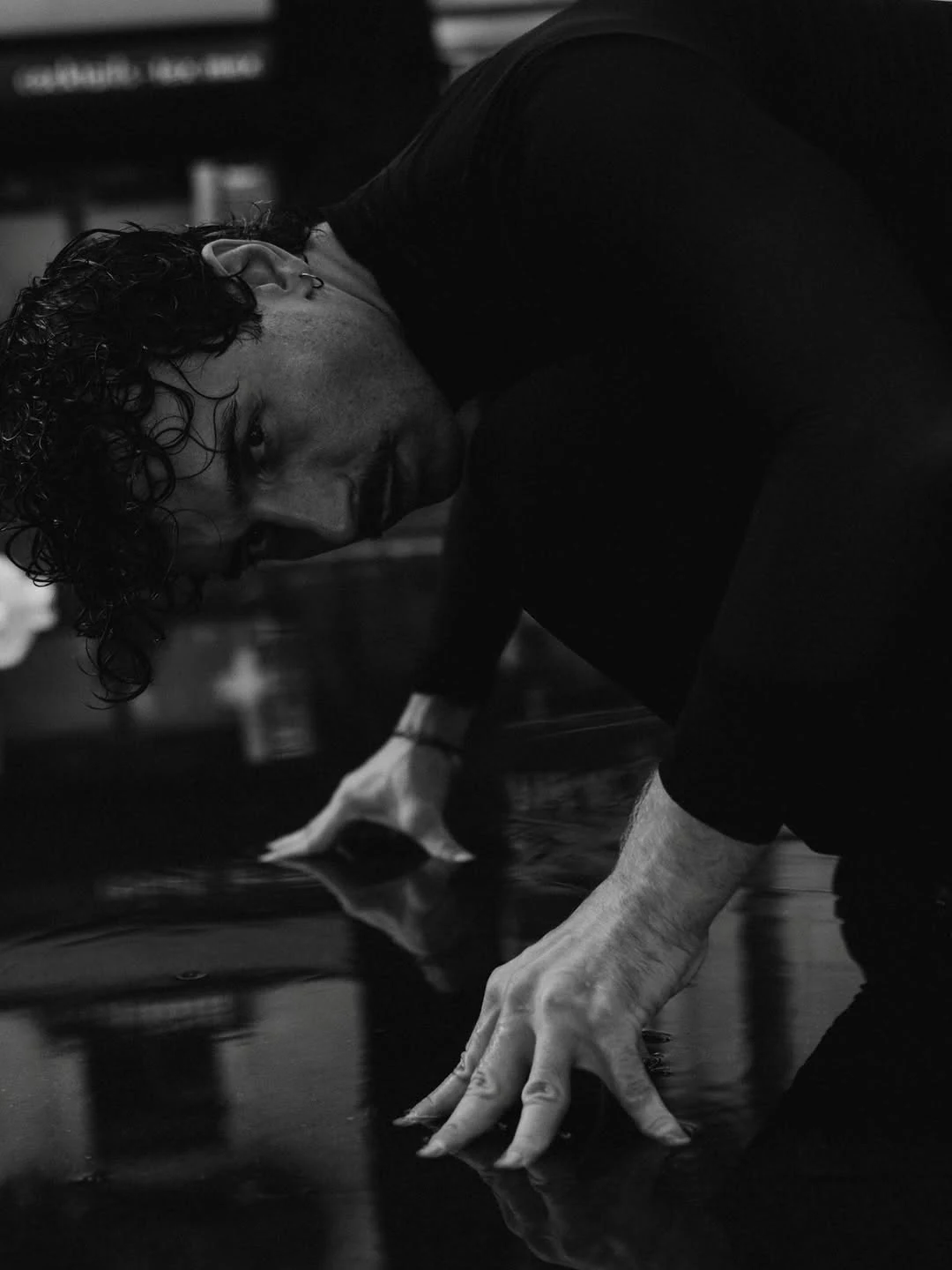 A quiet gesture captured in a black-and-white portrait